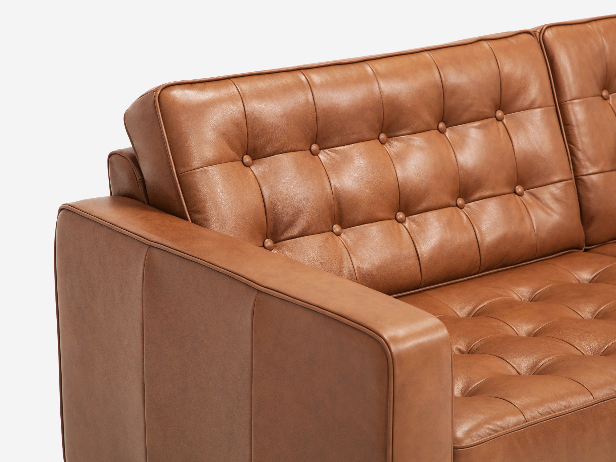 Detail left arm view of our mid century modern sofa, the Reverie 92", upholstered in brown leather